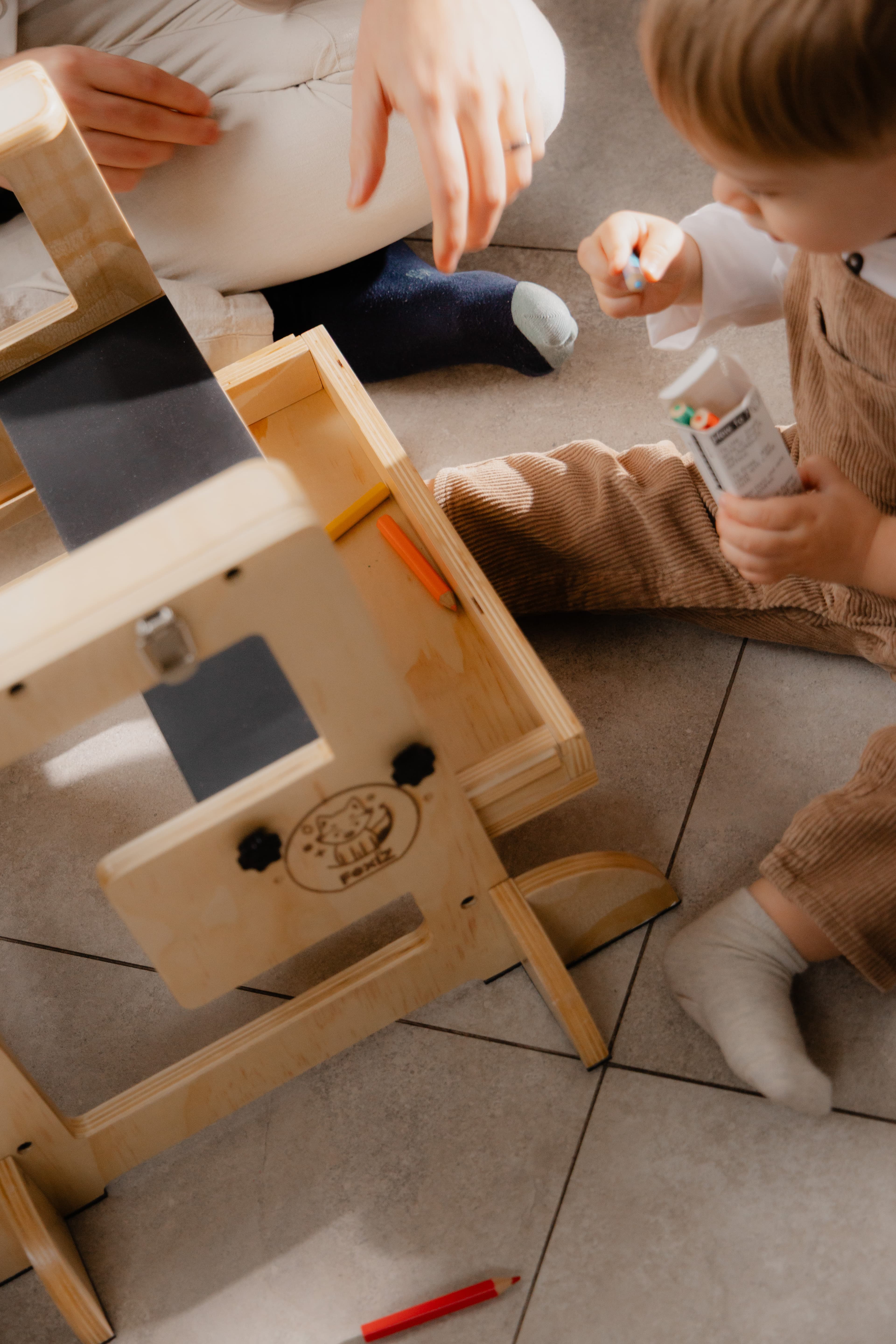 Child and parent assembling the tower together